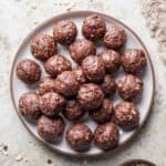 Date balls stacked on a serving plate.
