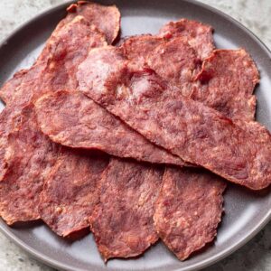 Turkey bacon piled on a gray plate.