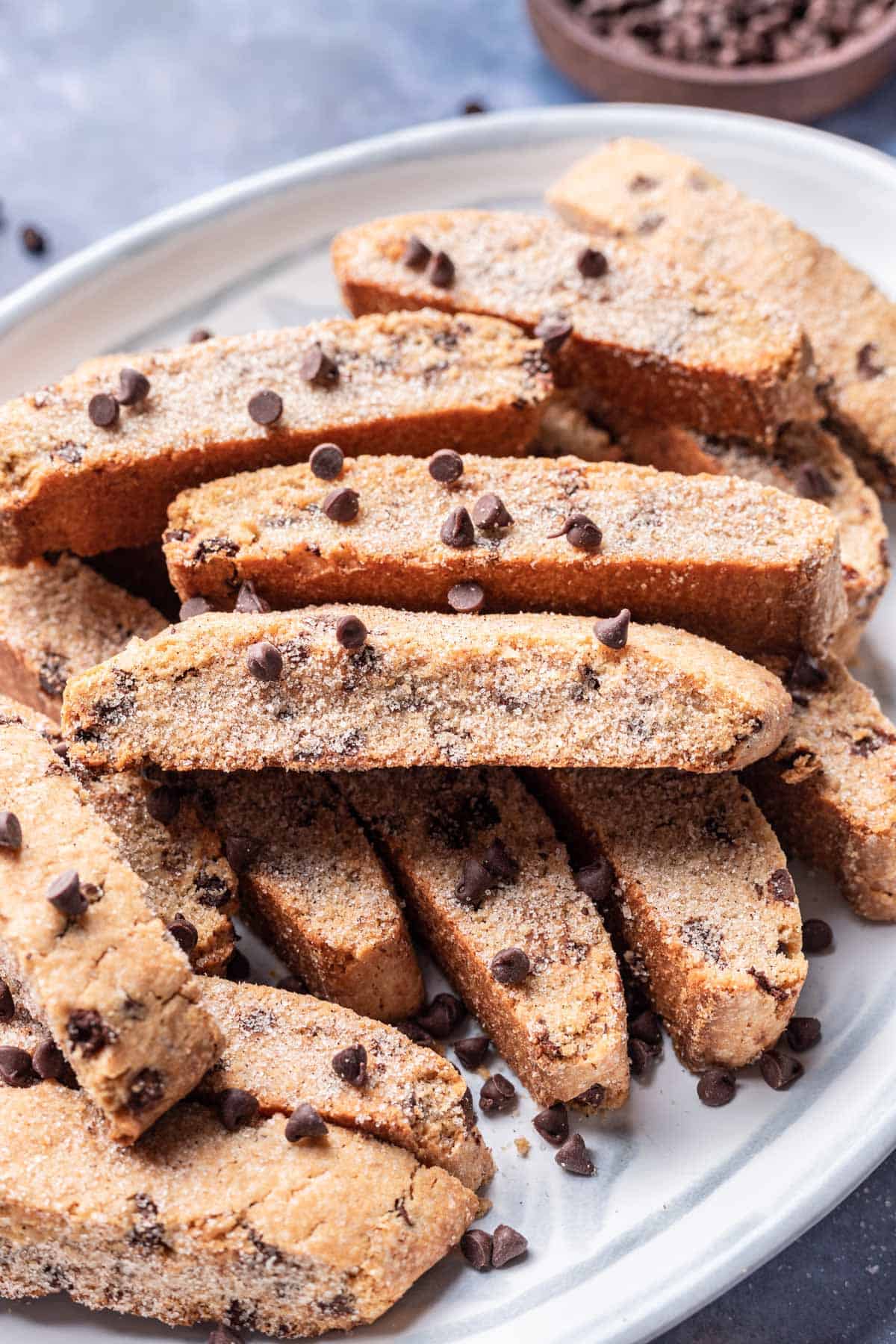 Passover mandel bread on a serving dish with chocolate chips on top.