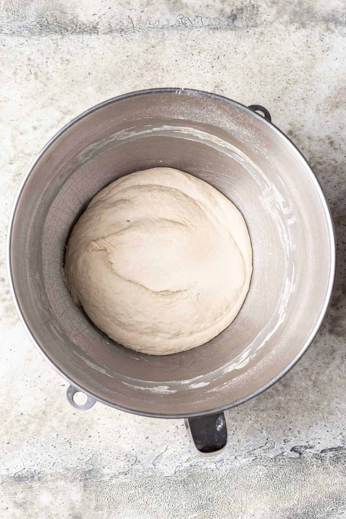 Beer pizza dough in a mixing bowl.