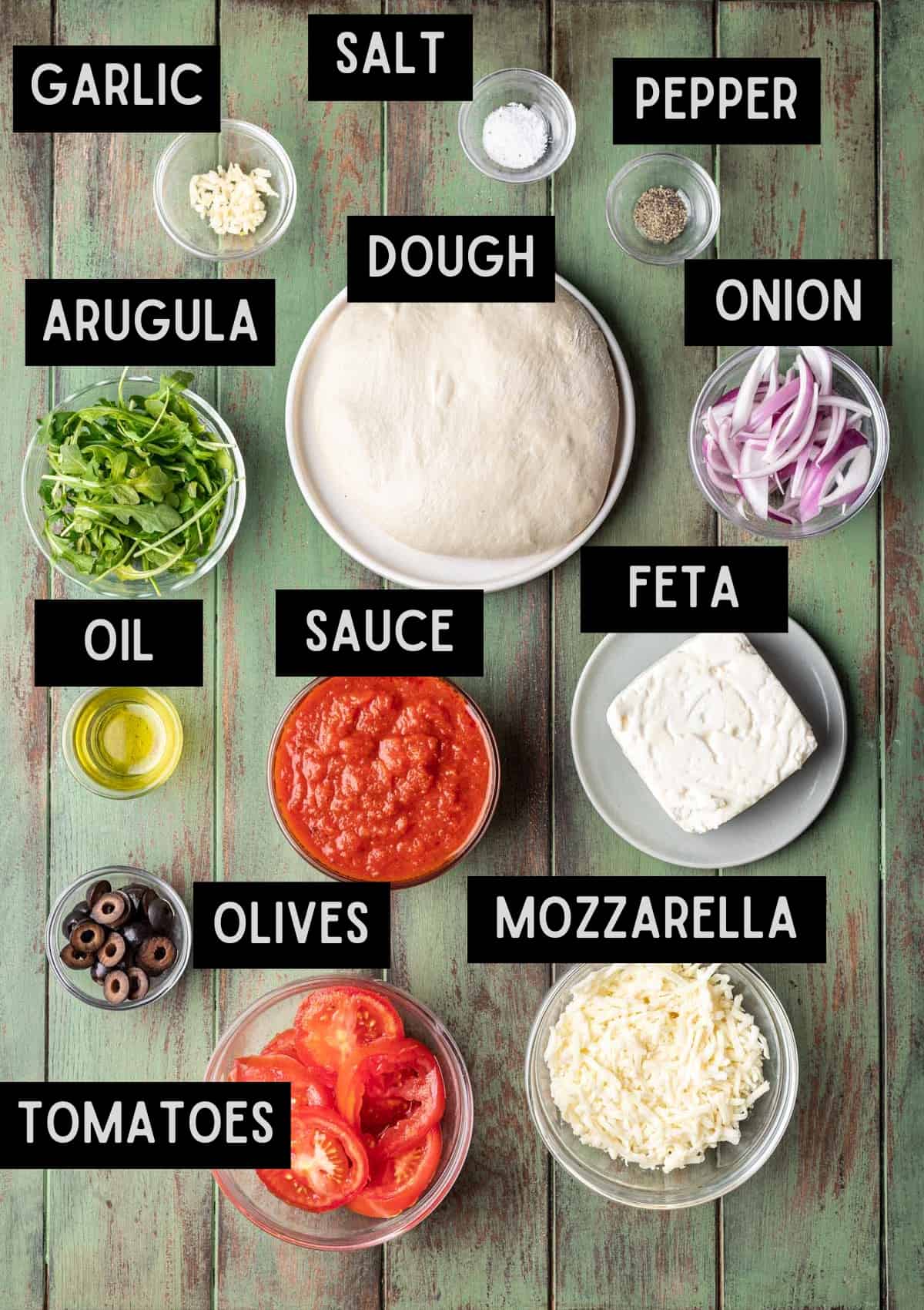 Labelled ingredients for mediterranean pizza (see recipe for details).