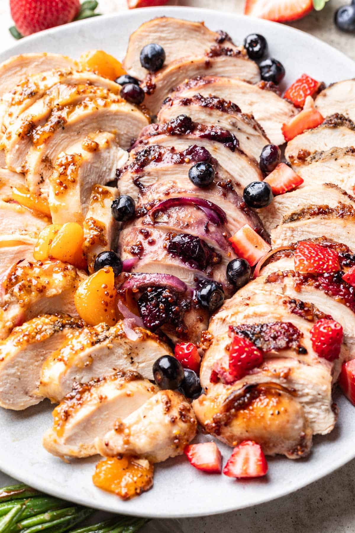 3 different flavors of jelly chicken sliced on a serving plate.