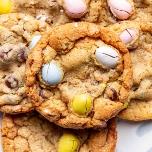 Mini easter egg cookies stacked on top of one another.