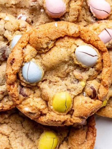 Mini easter egg cookies stacked on top of one another.