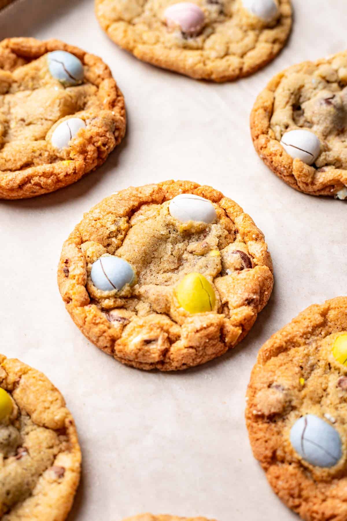 Mini easter egg cookies baked until golden brown on parchment paper.