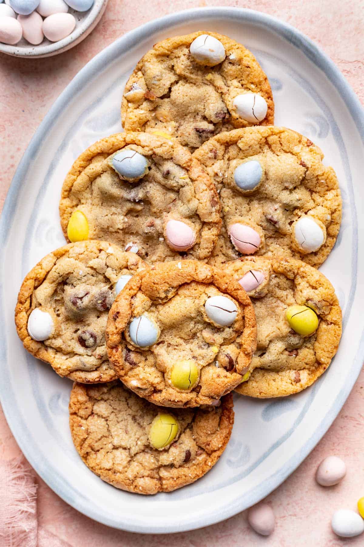 Mini easter egg cookies on a pastel blue plate.