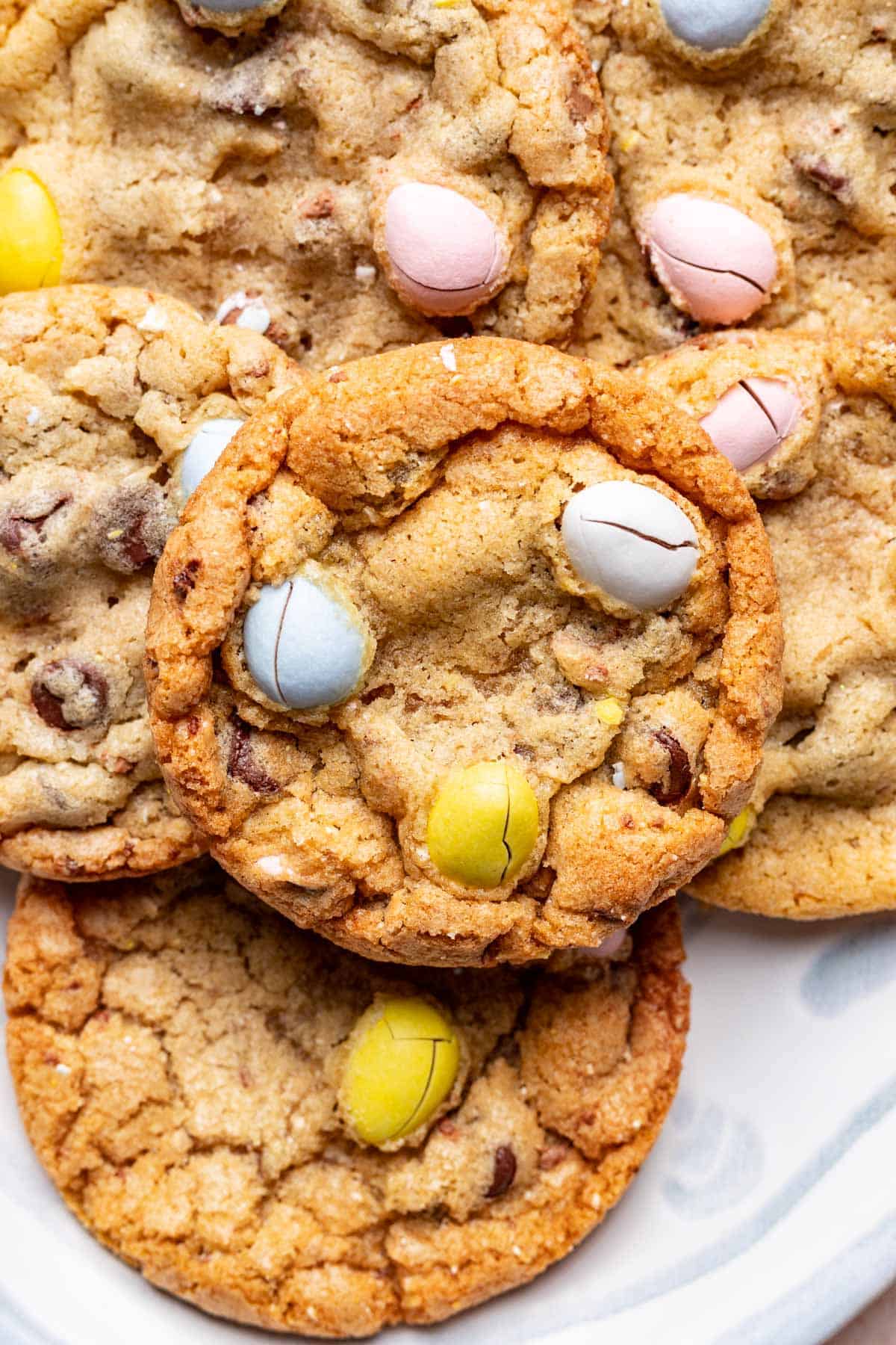 Mini easter egg cookies stacked on top of one another.