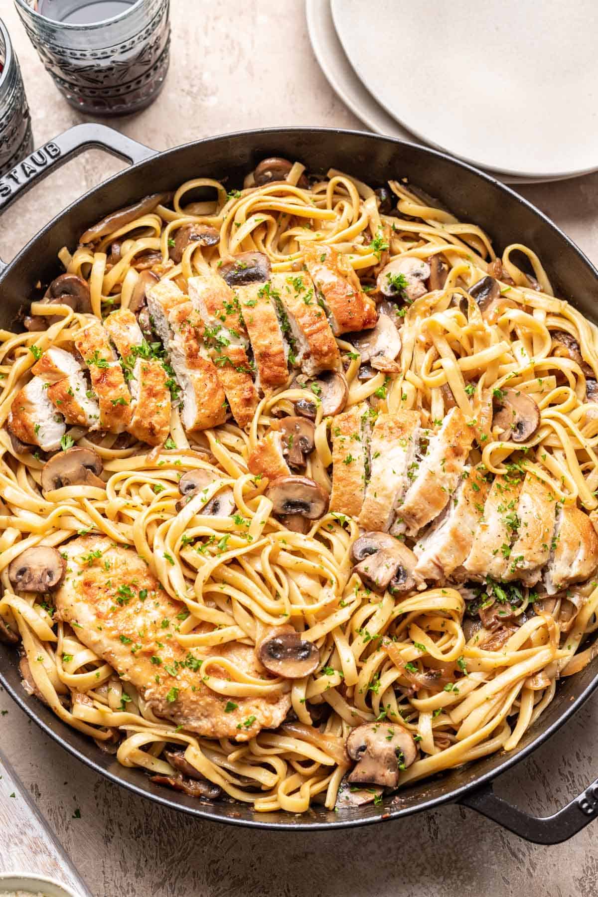 Chicken marsala fettuccine in a large skillet.