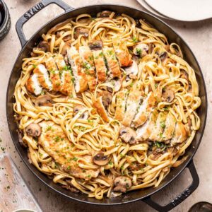 Chicken marsala fettuccine in a large skillet.