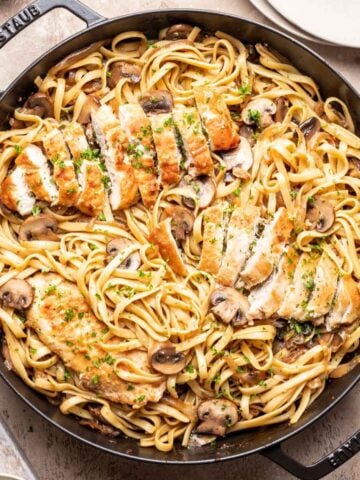 Chicken marsala fettuccine in a large skillet.