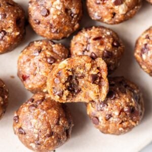 Peanut butter bliss balls with chocolate chips on a plate.