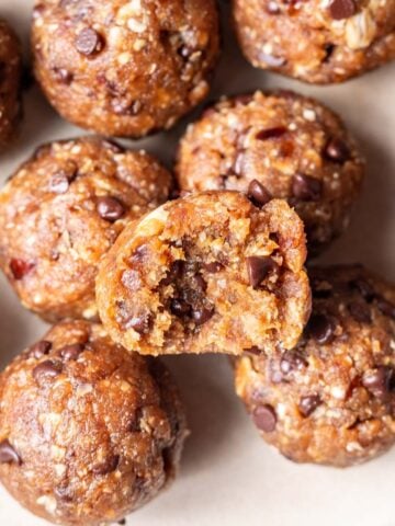 Peanut butter bliss balls with chocolate chips on a plate.