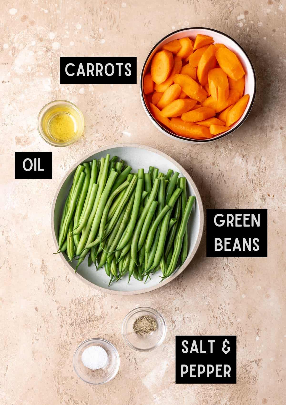 Labelled ingredients for roasted green beans and carrots (see recipe for details).