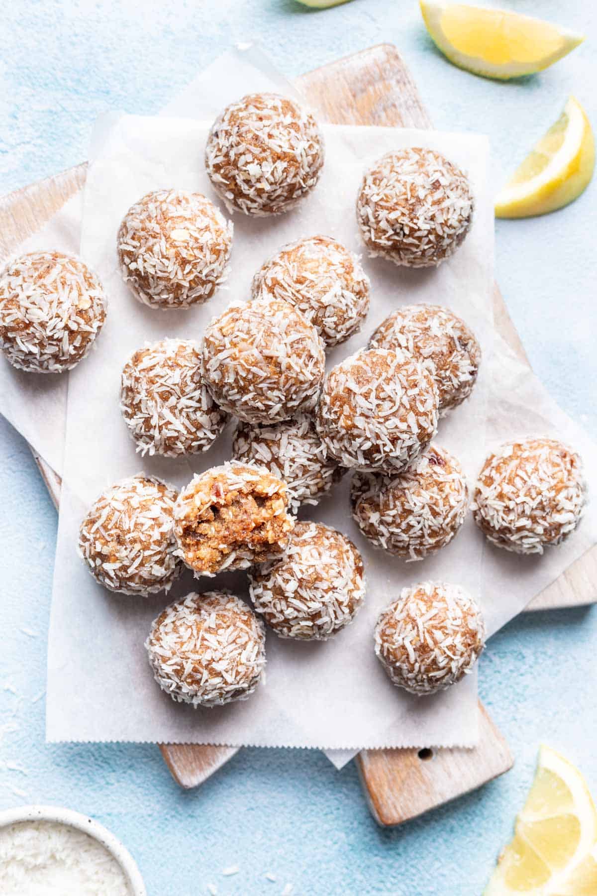 Lemon bliss balls on a serving board.