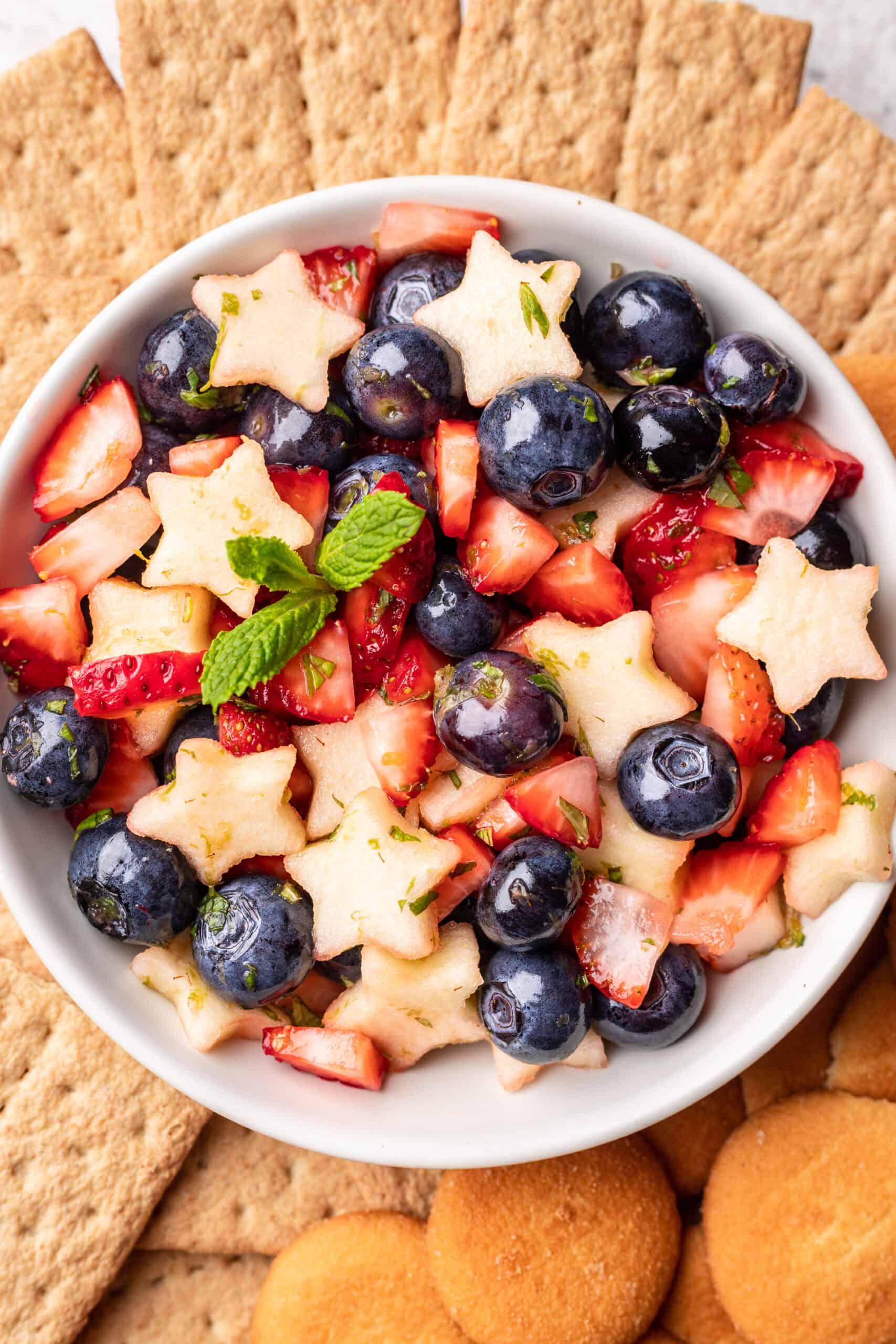 Close up view of red, white, and blue fruit salsa in a bowl.