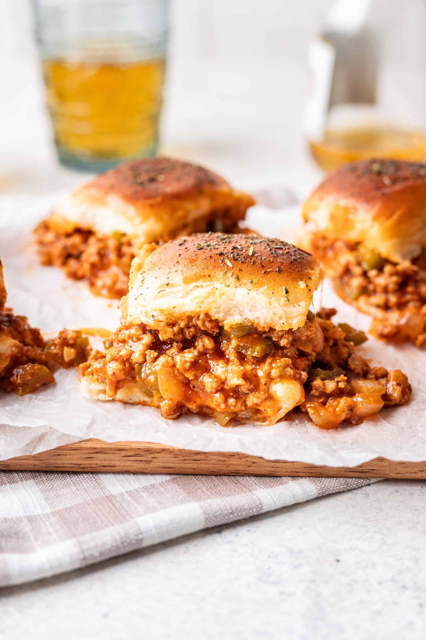 Sloppy joe sliders on a serving tray showing the filling falling out.