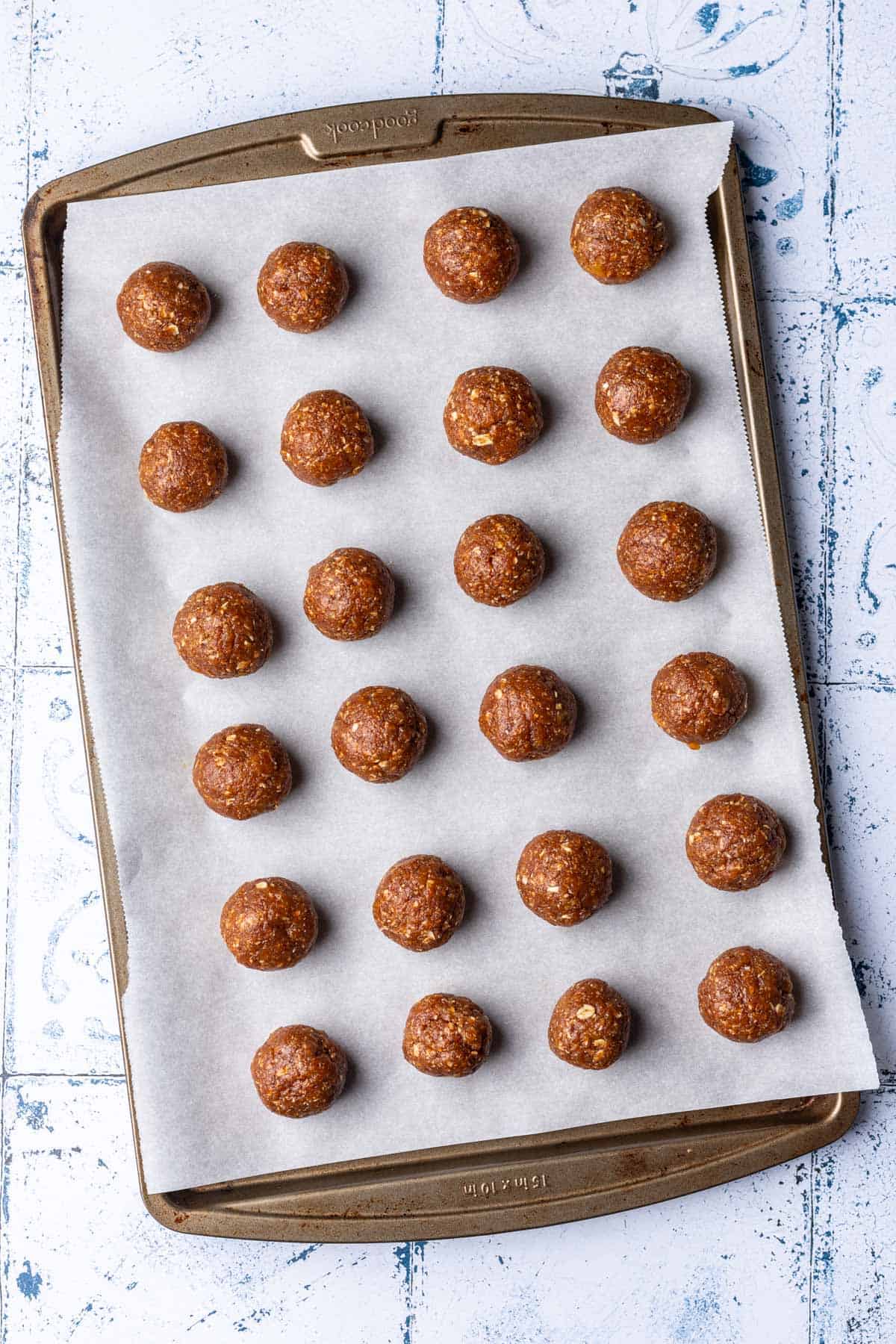 Apricot bliss balls arranged on a baking sheet.