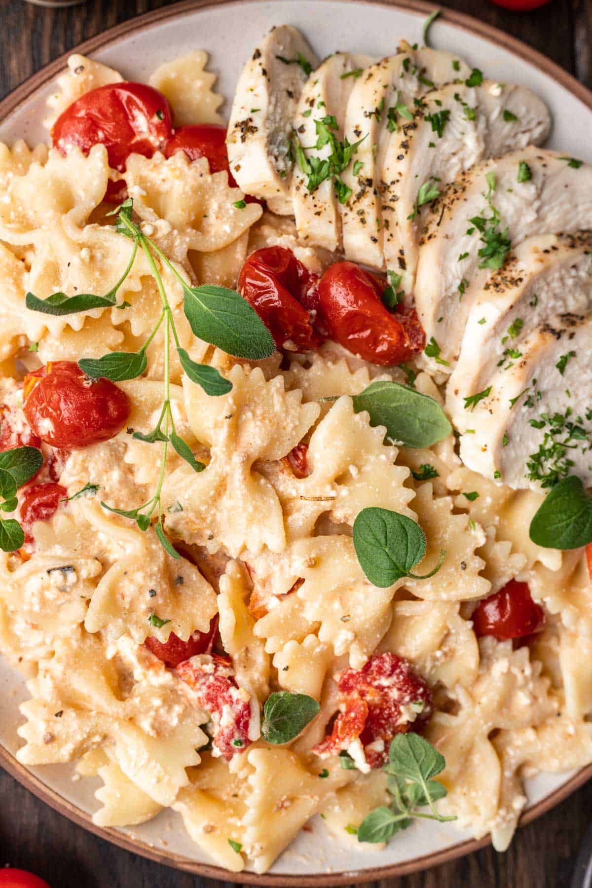 Bow ties noodles, cherry tomatoes, chicken, and fresh basil combined to make chicken feta pasta.