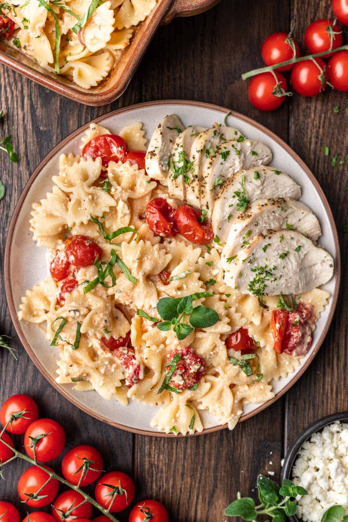 Chicken feta pasta on a plate with fresh basil.