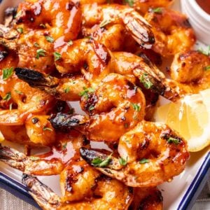 Shrimp with BBQ sauce on a platter.