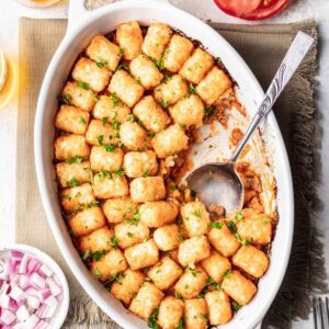 Cheeseburger tater tot casserole in an oval baking dish.