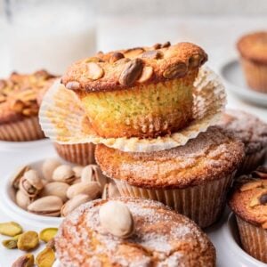 Pistachio muffins stacked on one another.