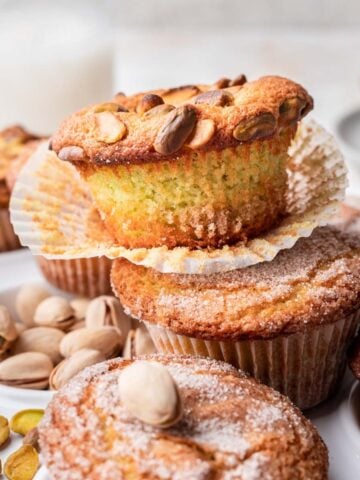 Pistachio muffins stacked on one another.