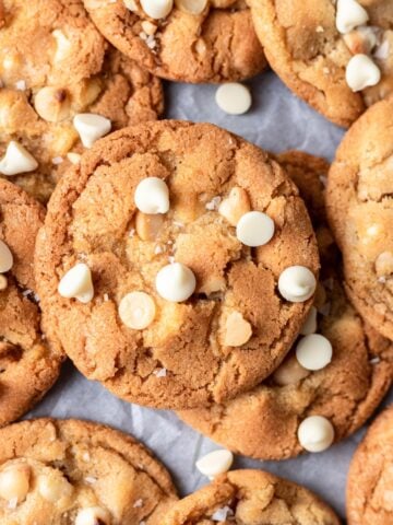 White chocolate macadamia nut cookies stacked on each other.