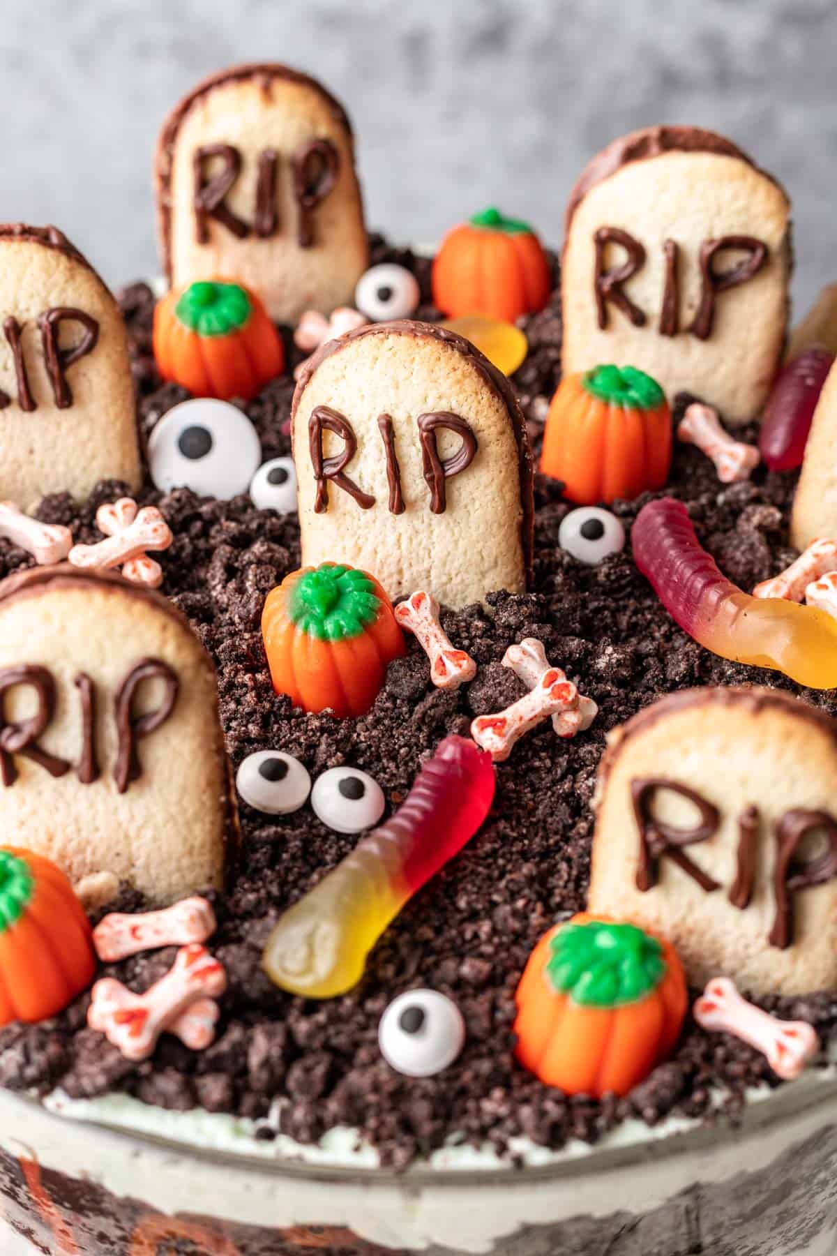 Top of the halloween trifle to show the "graveyard" of oreo dirt, cookie tombstones, candy bones, eyes, and worms.
