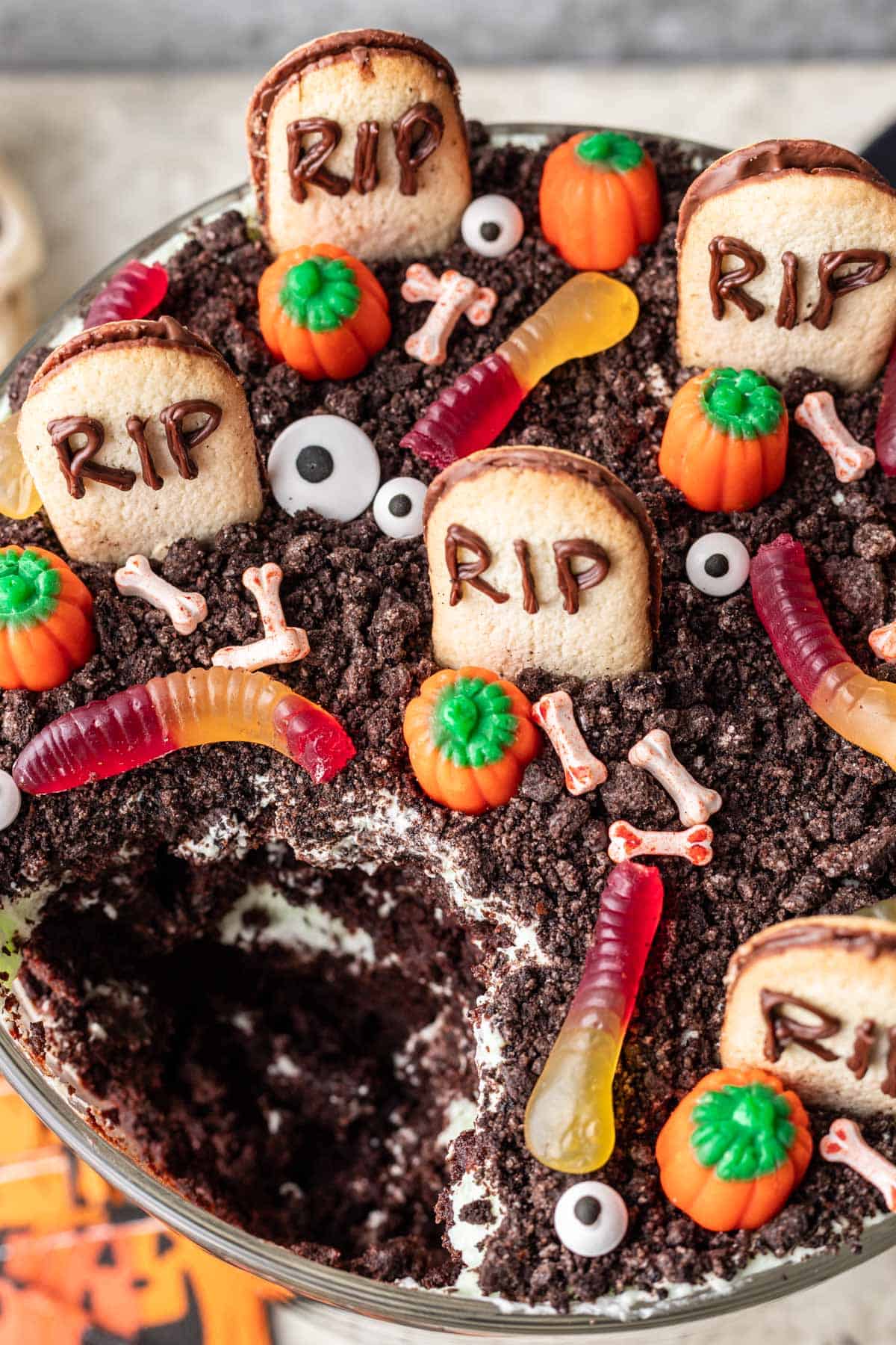 A scoop of halloween trifle removed from the dish to show the layers inside of the trifle.