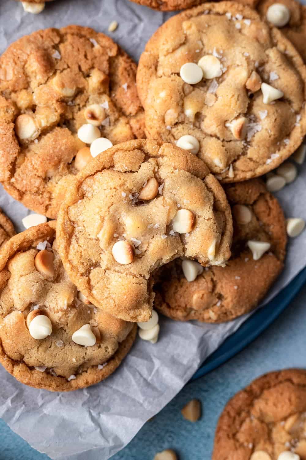 White chocolate macadamia nut cookies with a bite taken out.