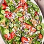Strawberry cucumber salad on a serving platter.