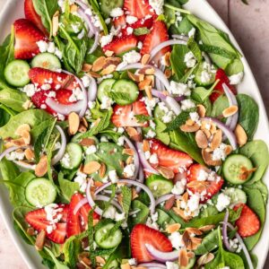 Strawberry cucumber salad on a serving platter.