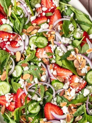 Strawberry cucumber salad on a serving platter.