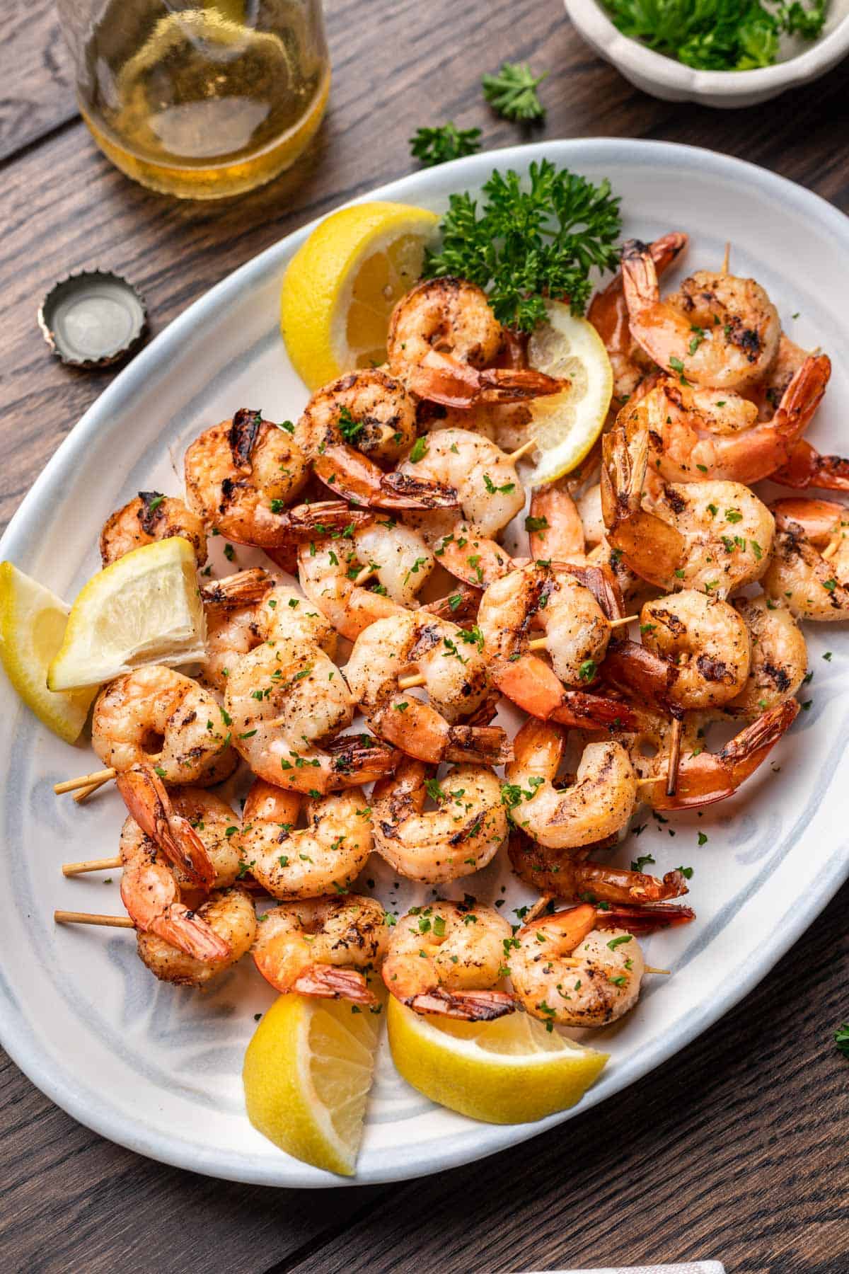 Smoked shrimp on a serving platter with lemons and parsley.