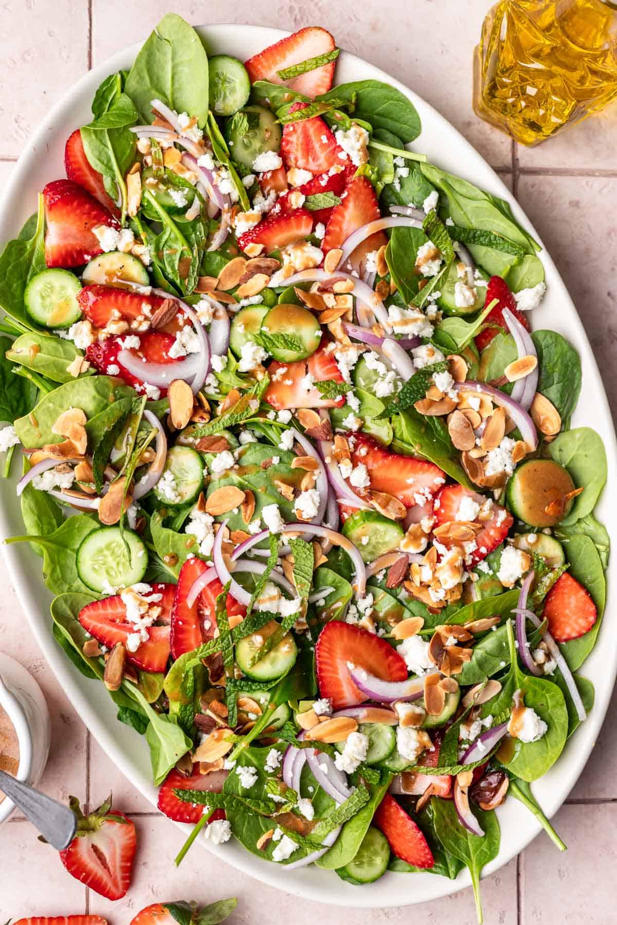 Strawberry cucumber salad drizzled with maple balsamic dressing.