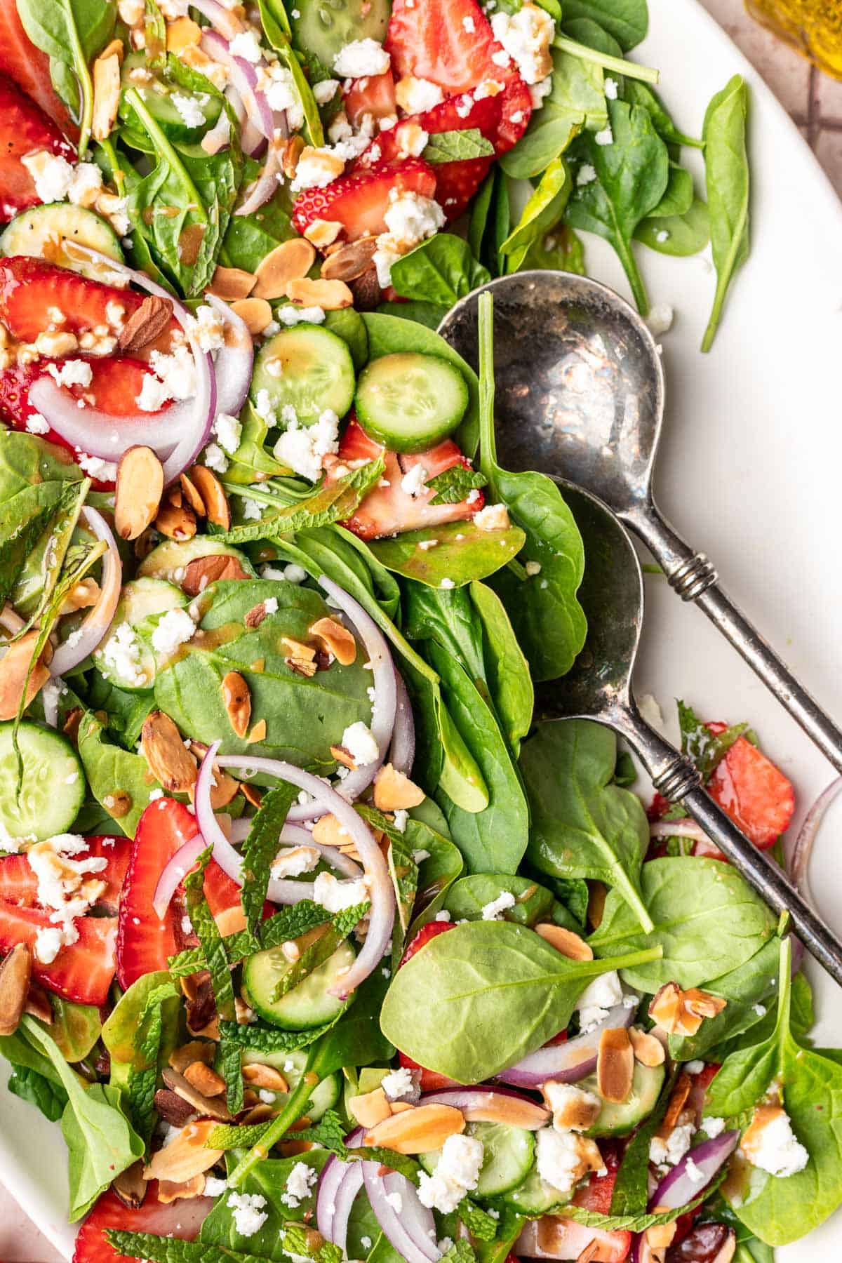 Maple balsamic dressing drizzled on a strawberry spinach salad.