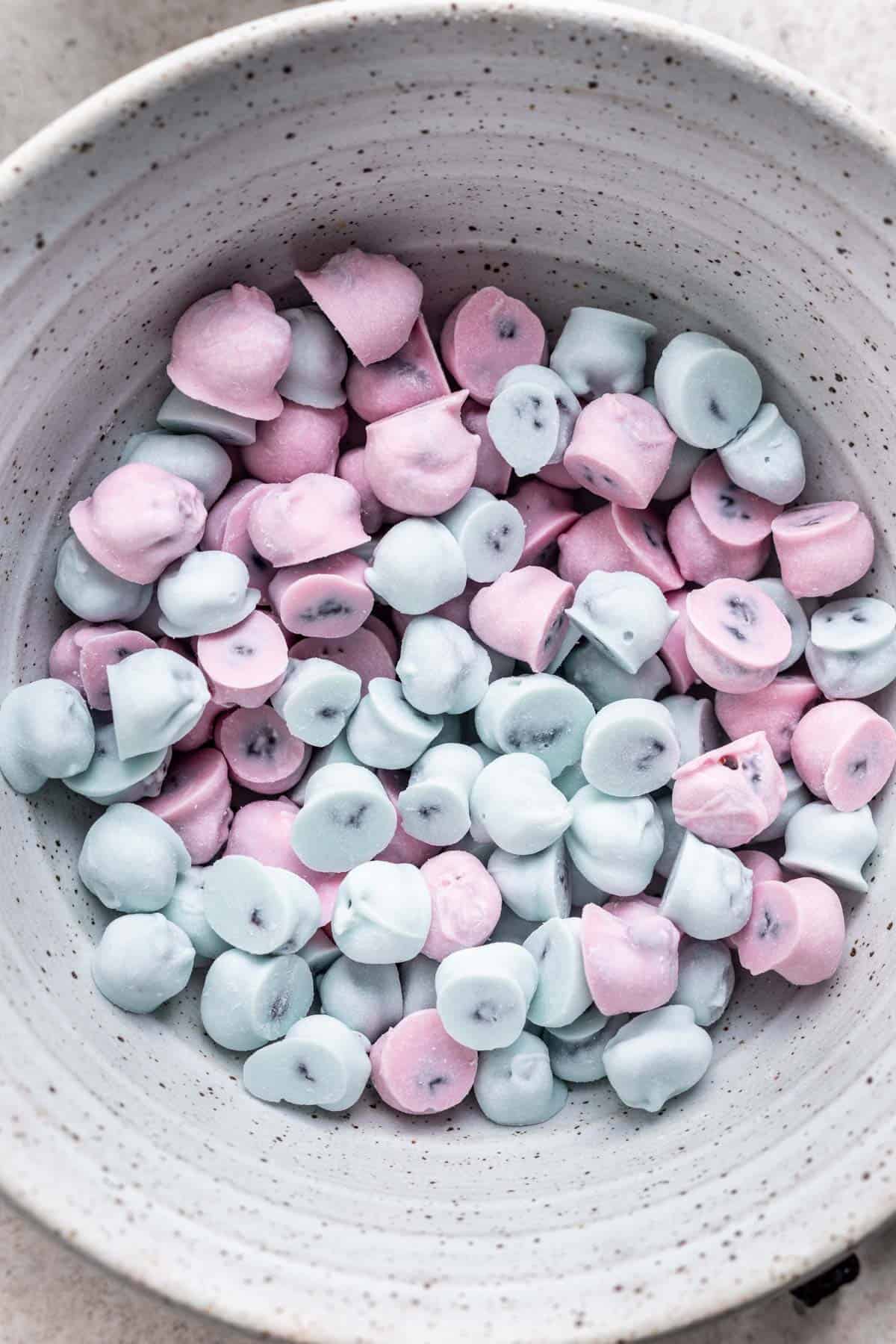 Blue and pink yogos in a bowl.