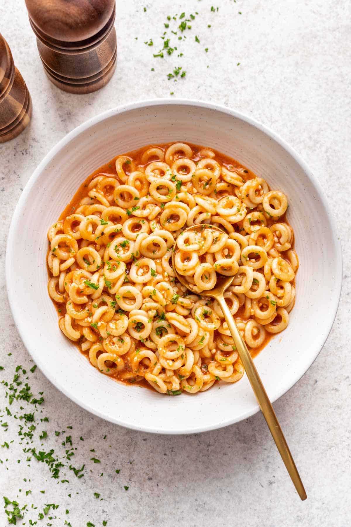 Homemade spaghettios in a bowl with a spoon.