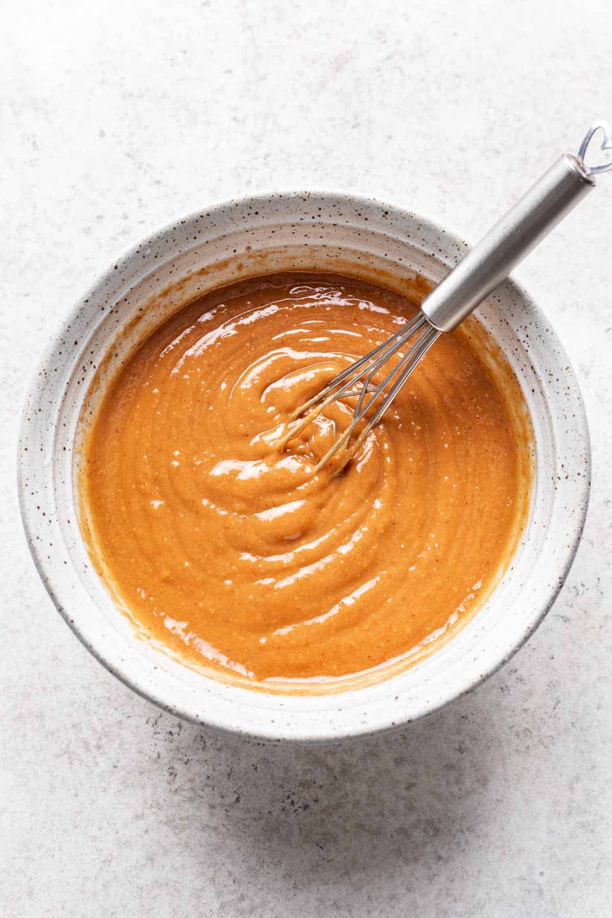 Spicy peanut sauce on a small bowl.