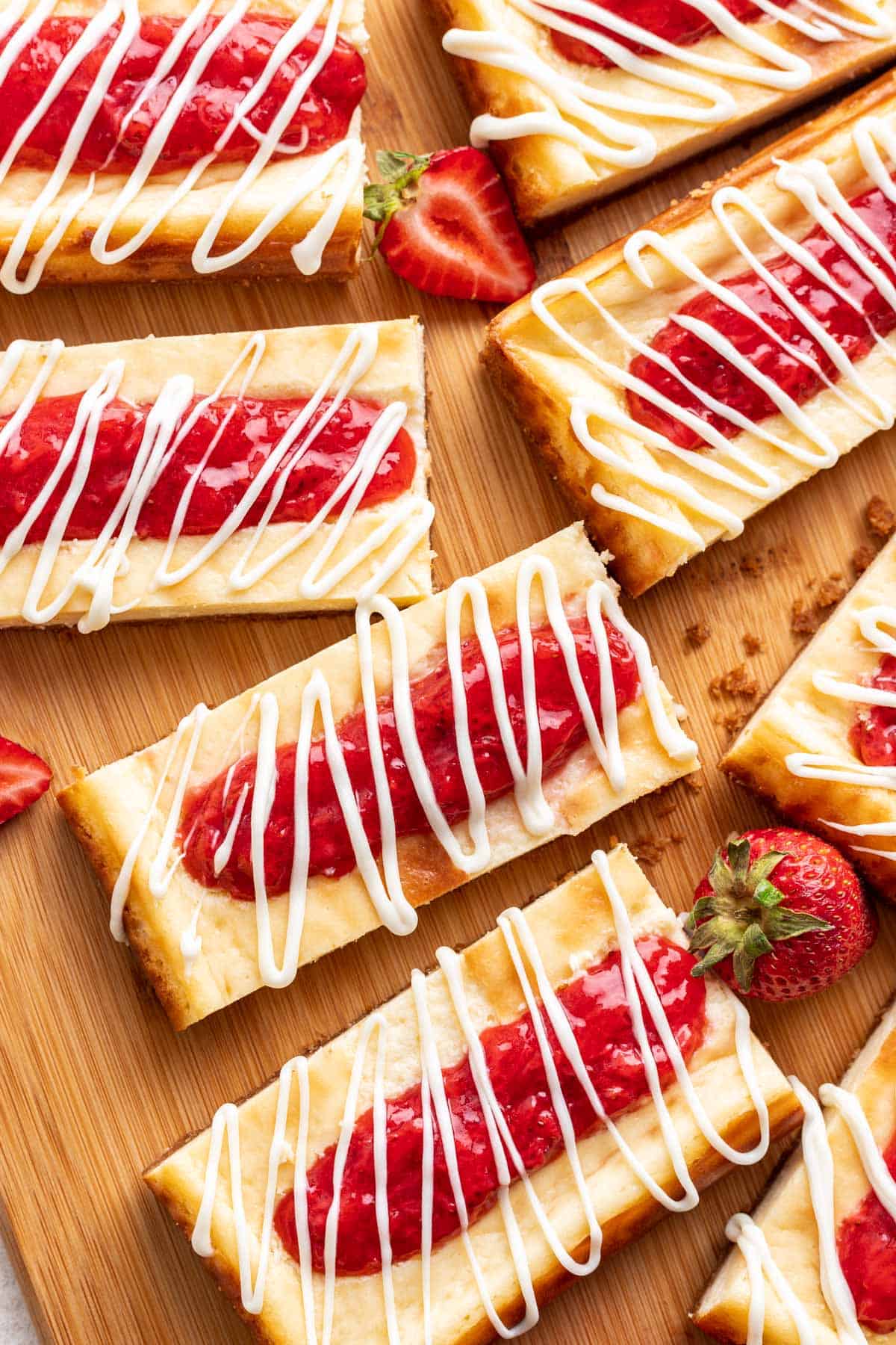Strawberry Cheesecake Bars with a drizzle of white chocolate on top.