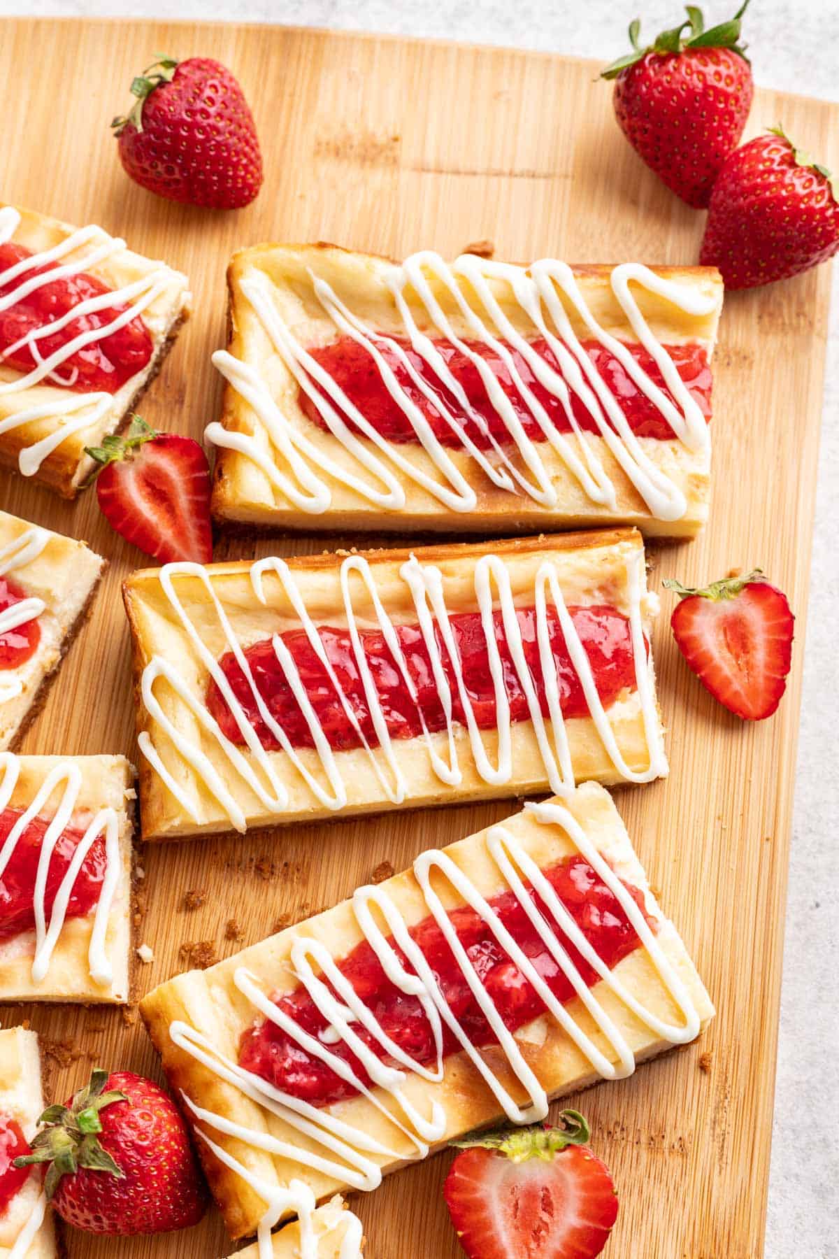 Copycat Philadelphia Cheesecake Bars with homemade strawberry jam on top.