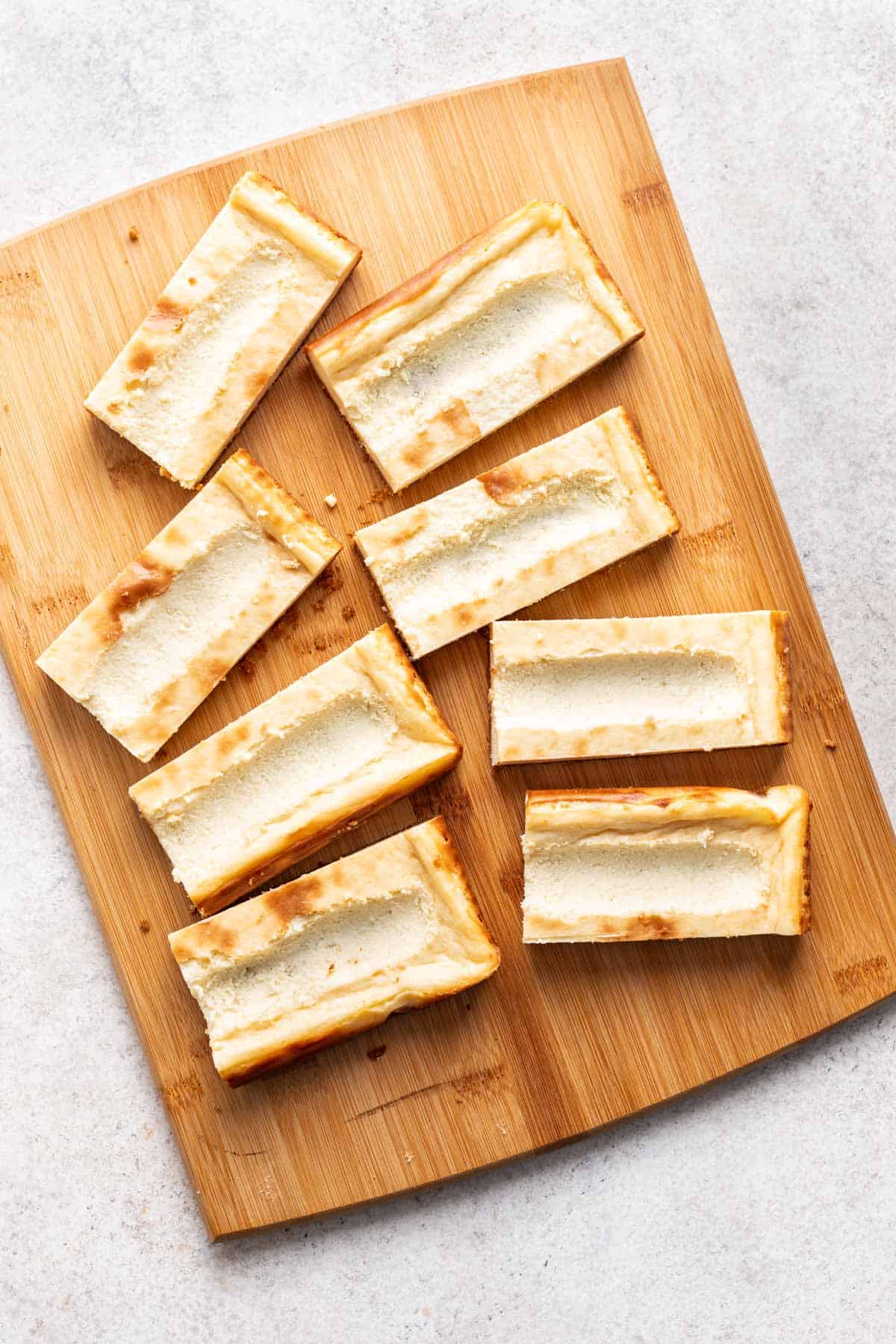 The center of the cheesecake bars scraped out for the strawberry filling.