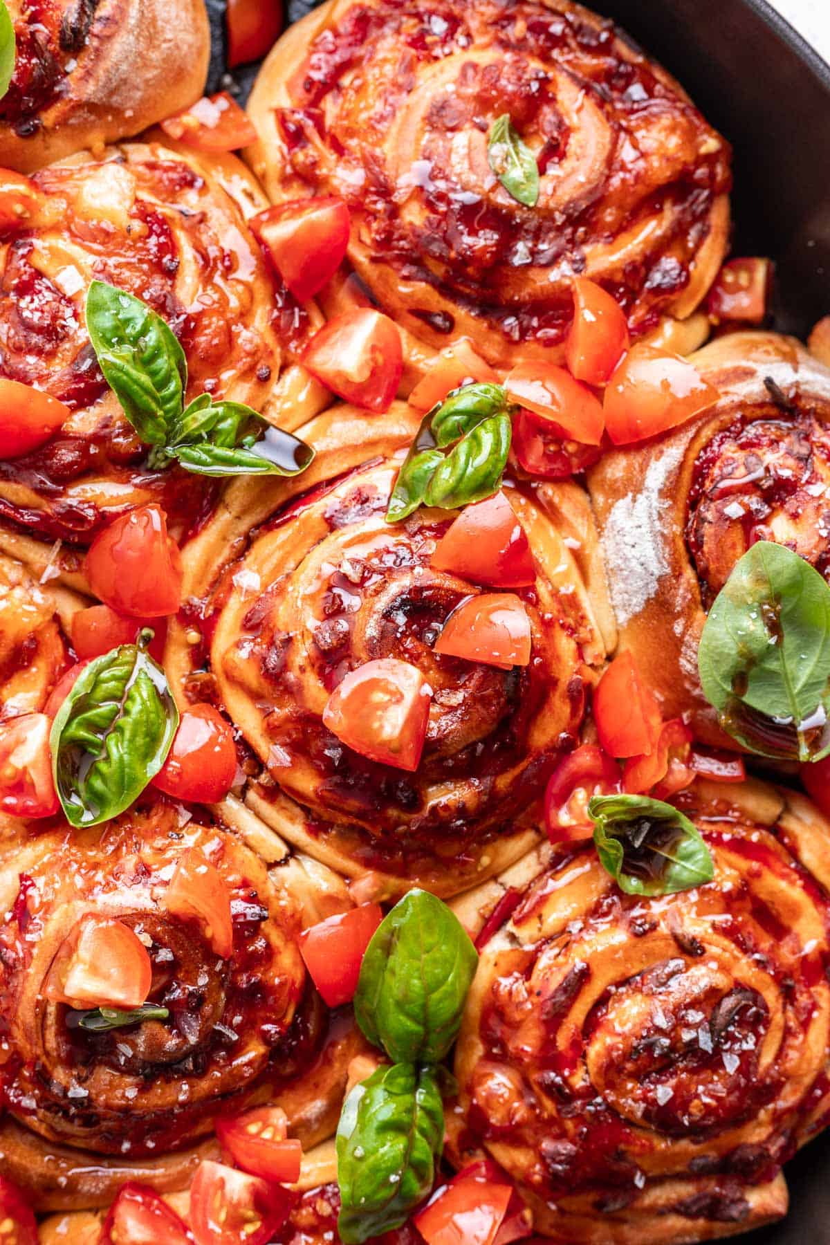 Caprese rolls topped with diced tomatoes and fresh basil.