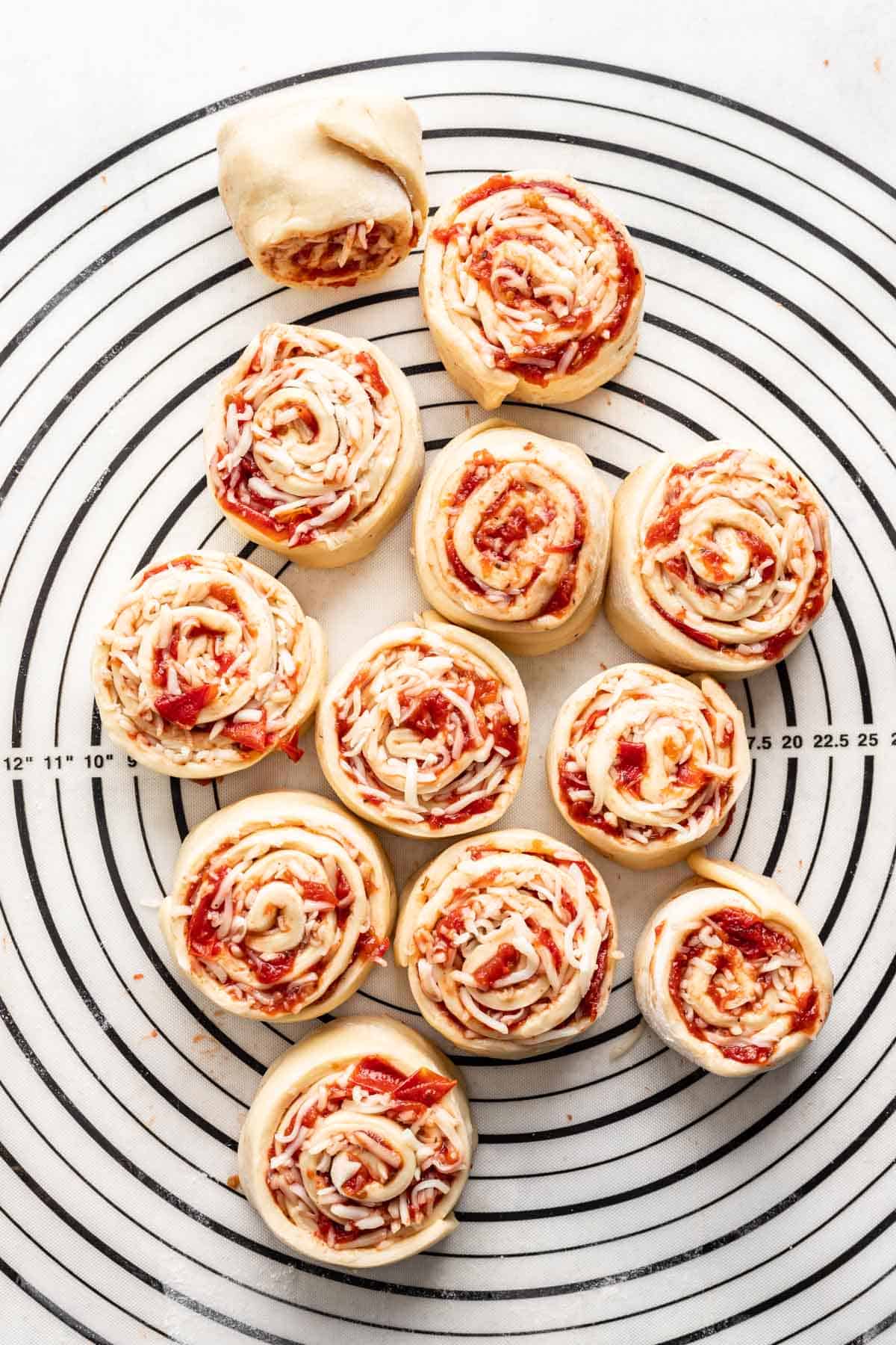 Caprese rolls rolled on a mat before baking.