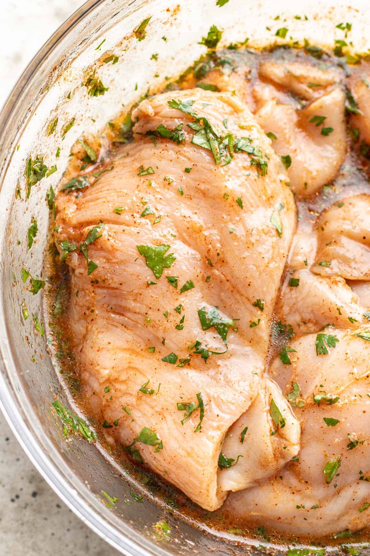 Raw chicken marinated in cilantro lime marinade just before grilling.