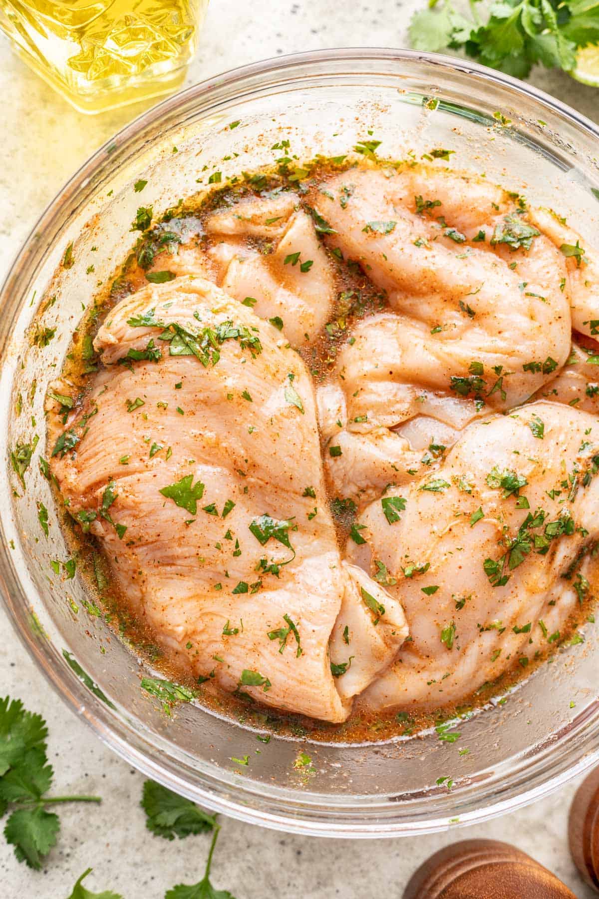 Cilantro lime chicken marinating in a bowl.