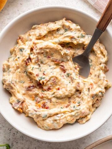 Sun dried tomato aioli in a bowl with a serving spoon.
