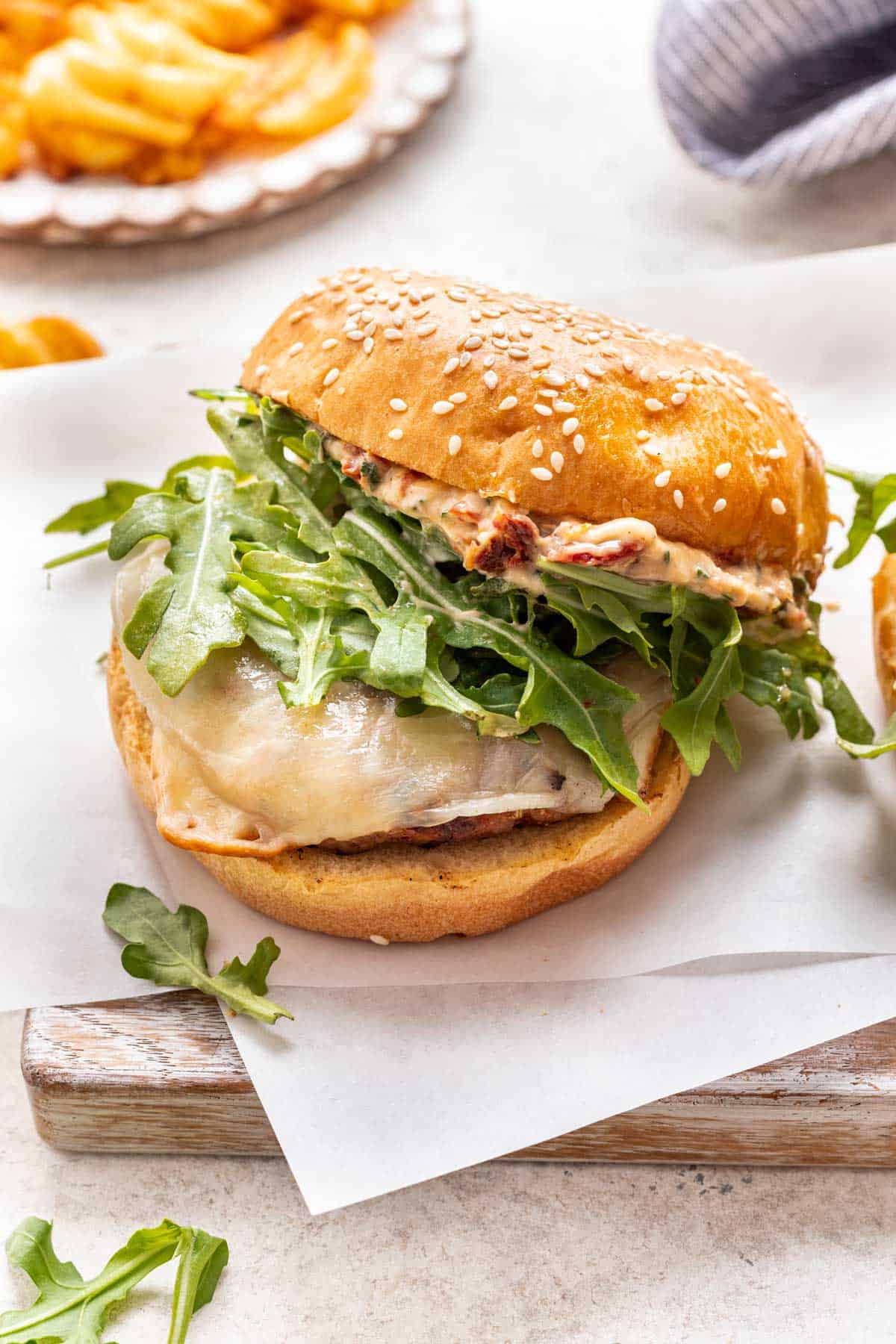 Marry me chicken burger with sun dried tomato aioli spread on the top bun.