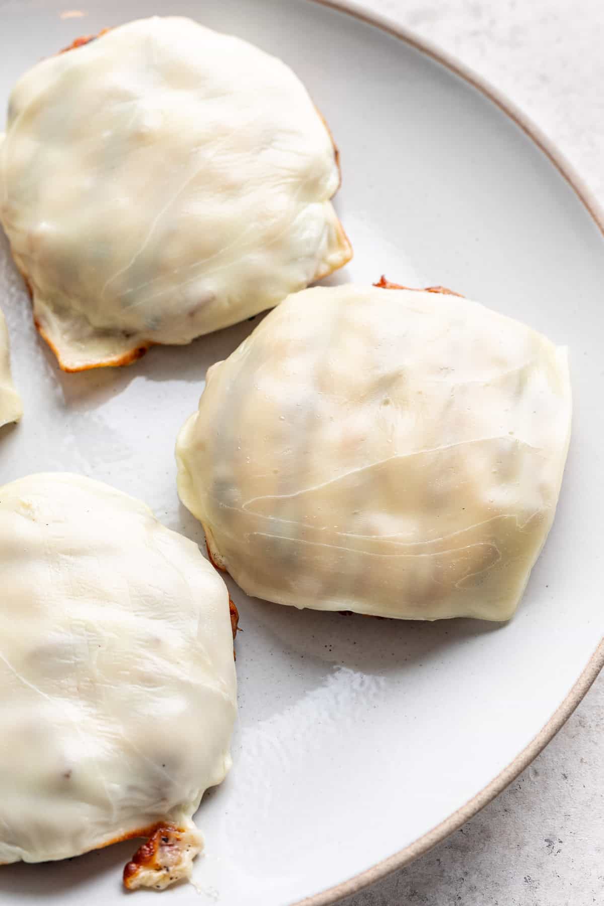 Marry Me Chicken Burger patties topped with mozzarella cheese.